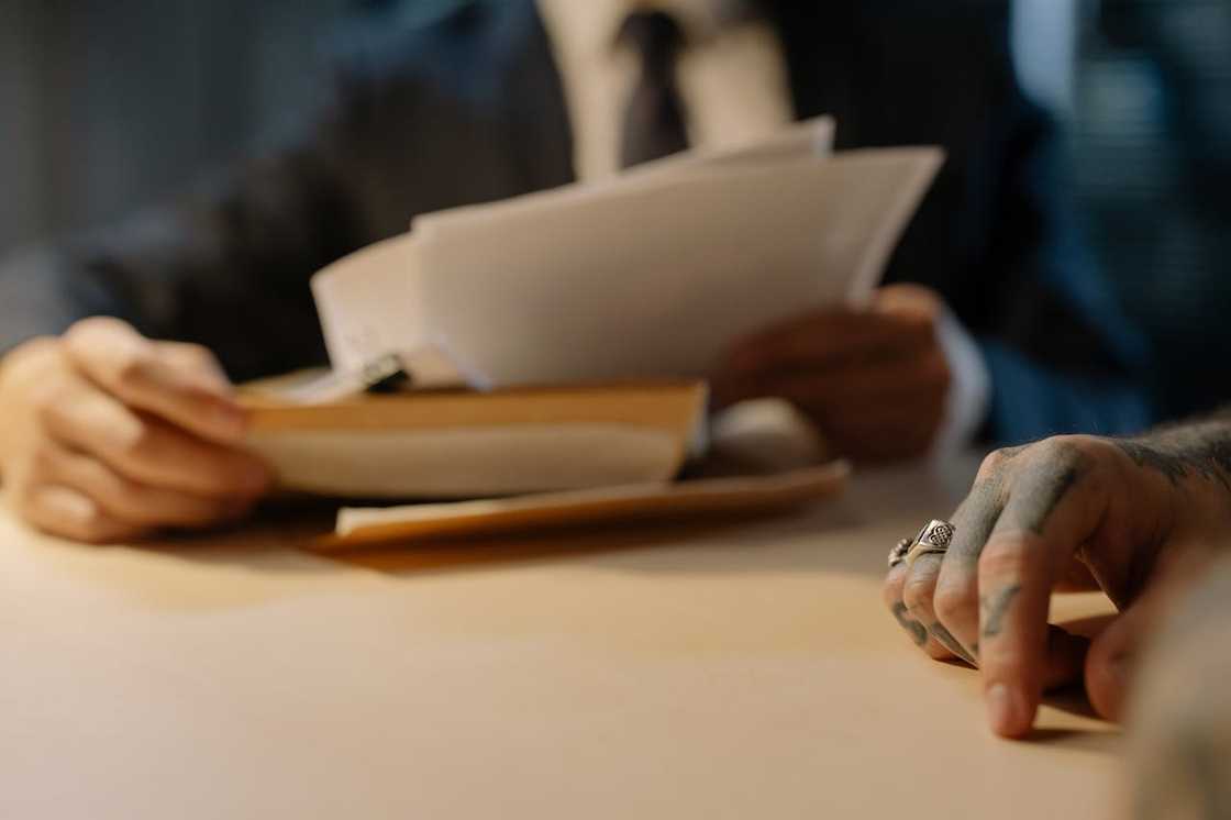 A detective looks at papers containing evidence.