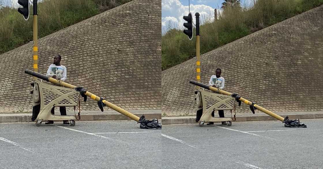 Mzansi Left Divided by Man Taking Traffic Light Using a Trolley Mzansi Left Divided by Man Taking Traffic Light Using a Trolley