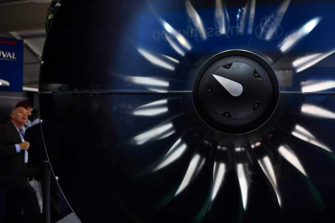 A visitor looks at a Pratt & Whitney engine during the Farnborough Airshow, in Britain in July 2018