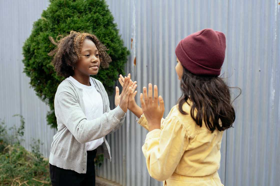 Young girls playing together with hands