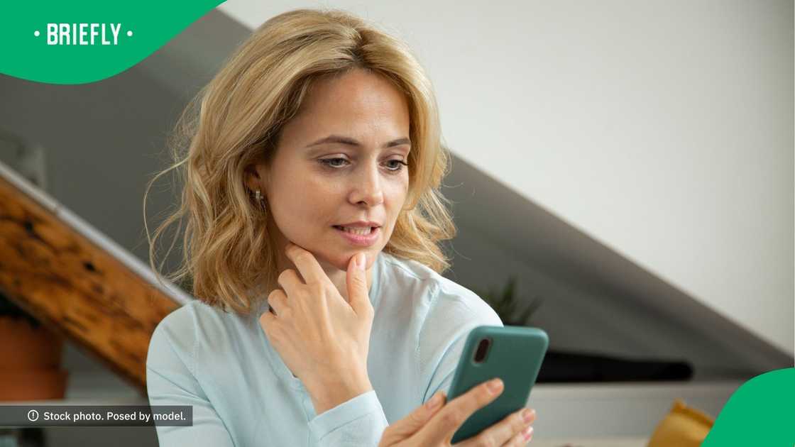 A woman looking at her phone. A woman looking at her phone.