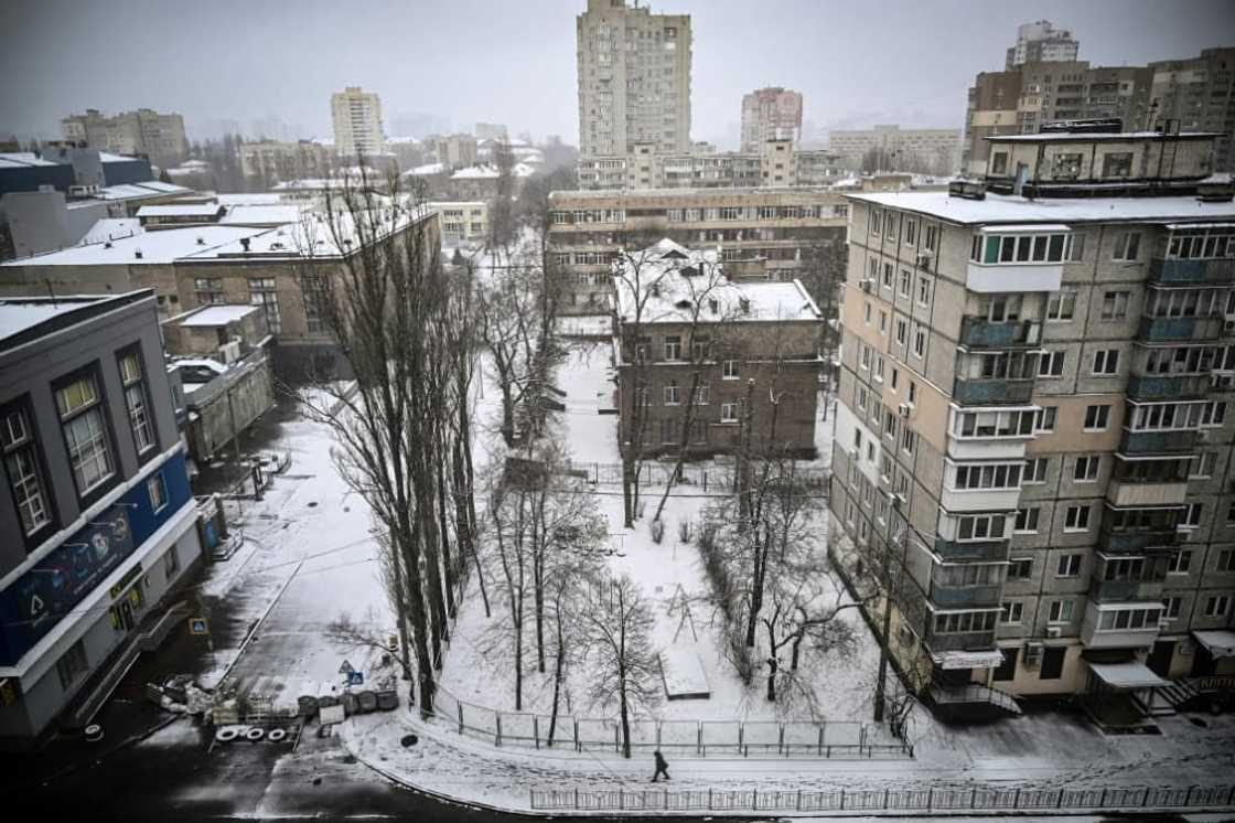 A man walks on the snow-covered pavement in the Ukrainian capital Kyiv in March 2022