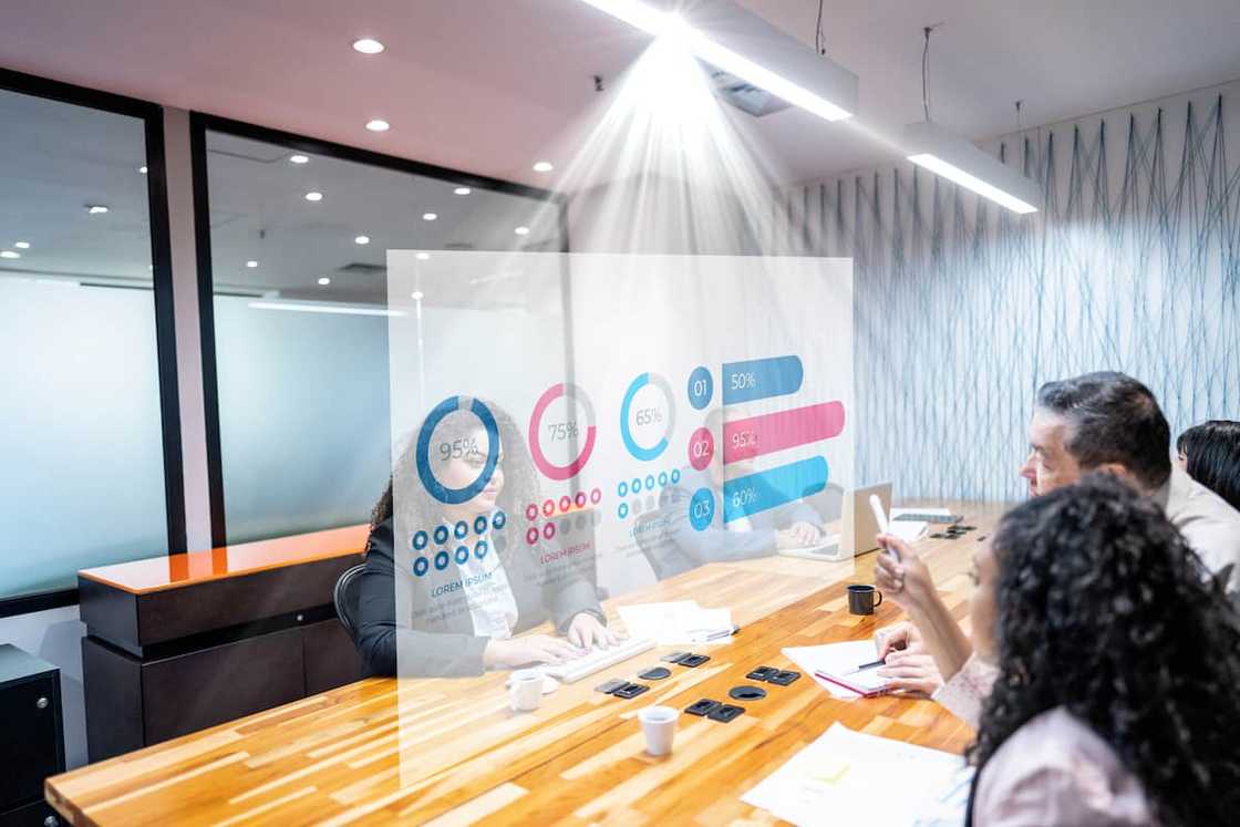 Individuals interpreting data on a hologram Individuals interpreting data on a hologram