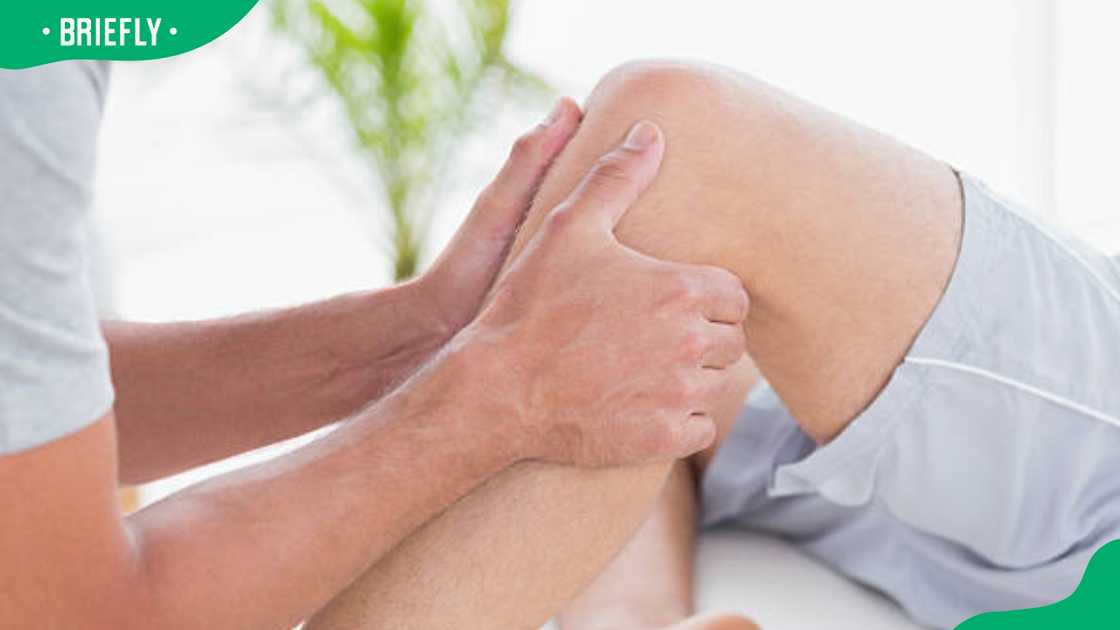 Man having knee massage in medical office Man having knee massage in medical office