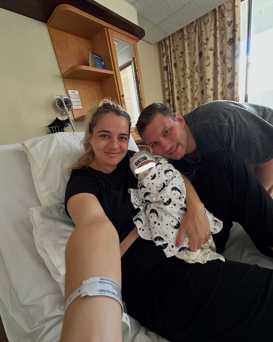 A mother and father showed their newborn to the world.