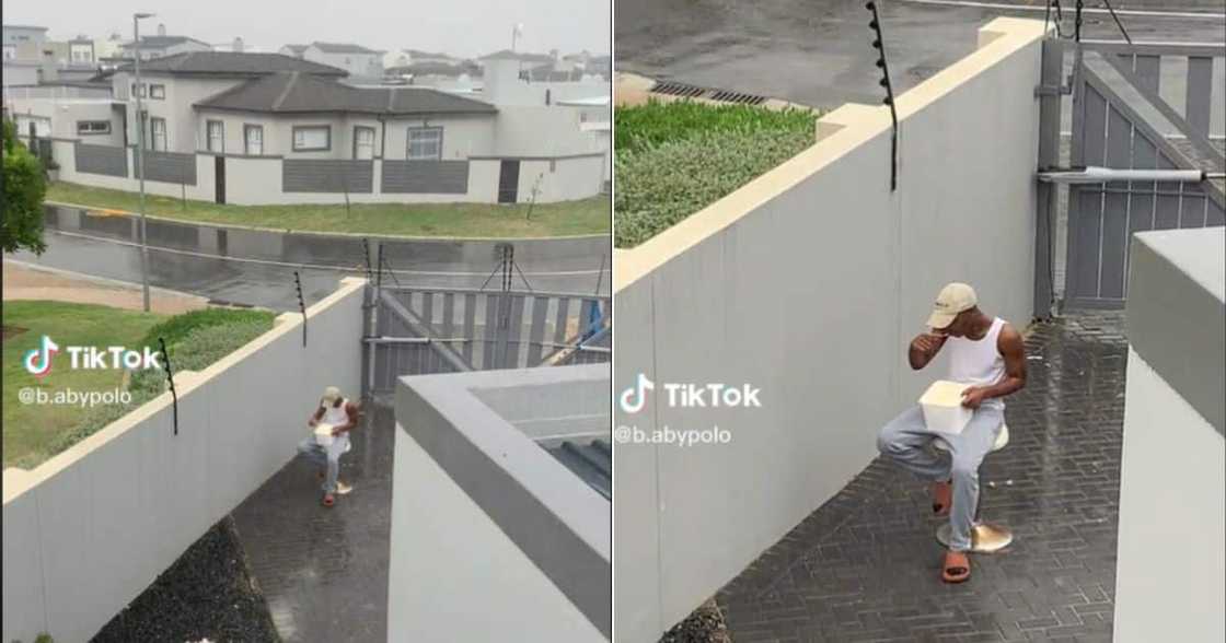 Man looks miserable eating ice cream in the rain