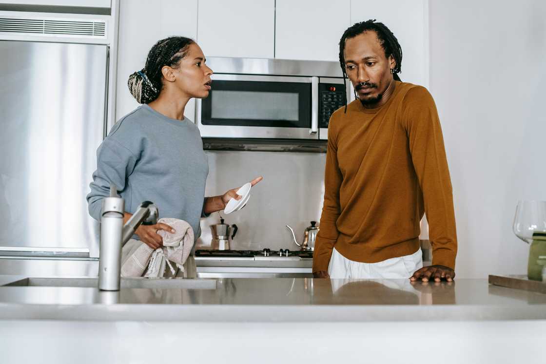 A couple arguing in the kitchen