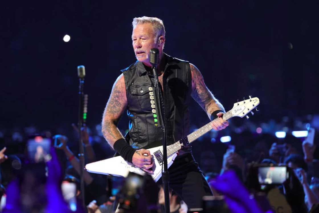 James Hetfield playing the guitar during a concert James Hetfield playing the guitar during a concert