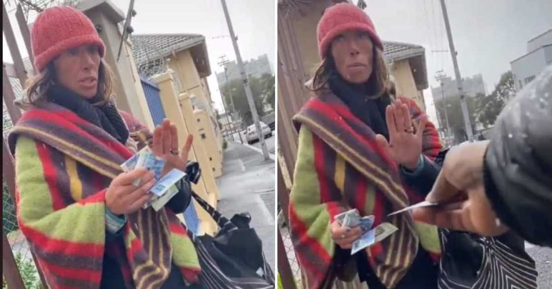 Bi Phakathi hands out money to a homeless woman Bi Phakathi hands out money to a homeless woman