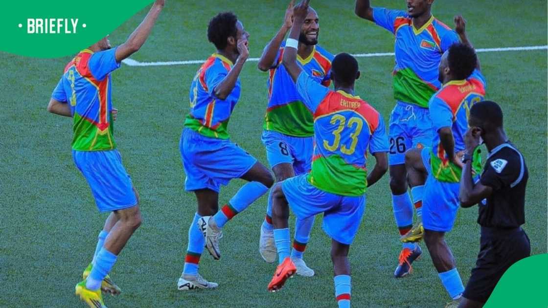 Eritrea national football team players celebrate together on the pitch after defeating Eswatini to qualify for the 2027 AFCON qualifiers, with players raising their arms and embracing in jubilation during the historic victory. Eritrea national football team players celebrate together on the pitch after defeating Eswatini to qualify for the 2027 AFCON qualifiers, with players raising their arms and embracing in jubilation during the historic victory.