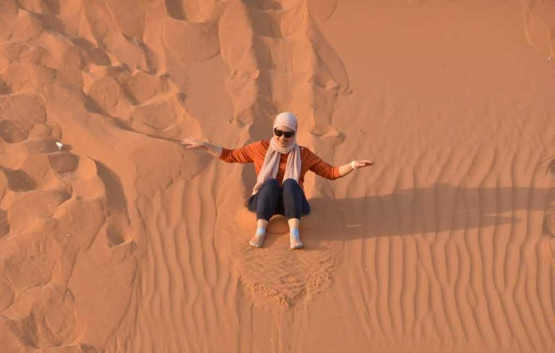 A woman surfs down a sand dune in the "Saed" desert area, 110 kilometres east of Riyadh A woman surfs down a sand dune in the "Saed" desert area, 110 kilometres east of Riyadh
