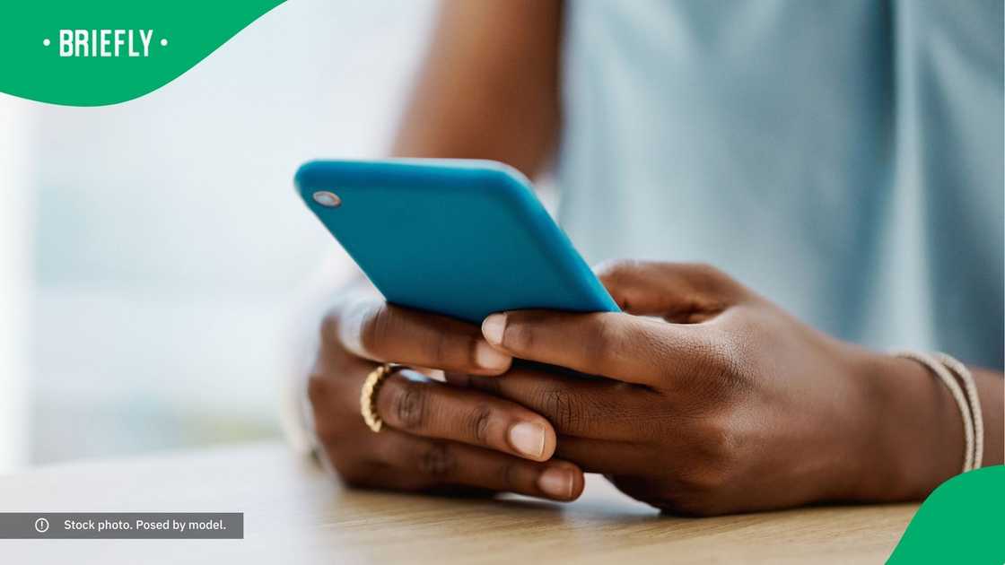 A woman typing on her phone. A woman typing on her phone.