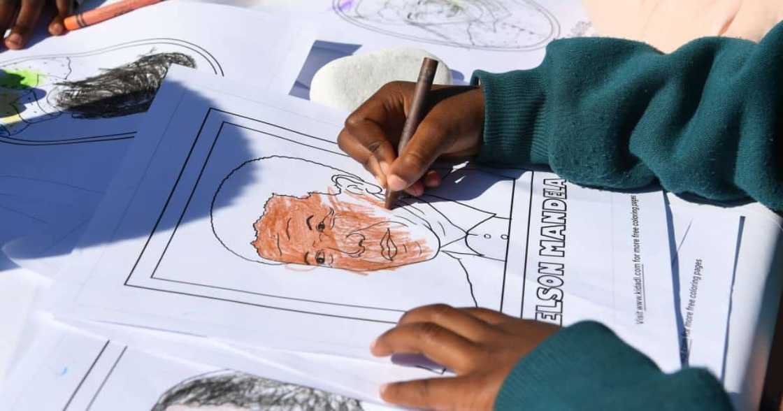 Child colouring in picture of Nelson Mandela Child colouring in picture of Nelson Mandela