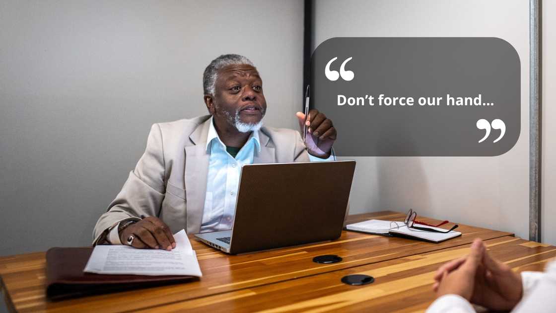 A seious councillor talking to someone in the office A seious councillor talking to someone in the office
