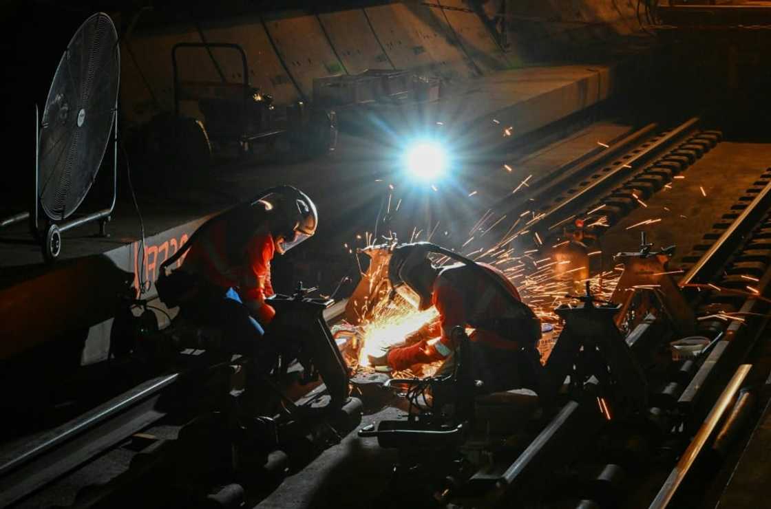 Maintenance staff have to be quick to finish before trains start up again at dawn Maintenance staff have to be quick to finish before trains start up again at dawn