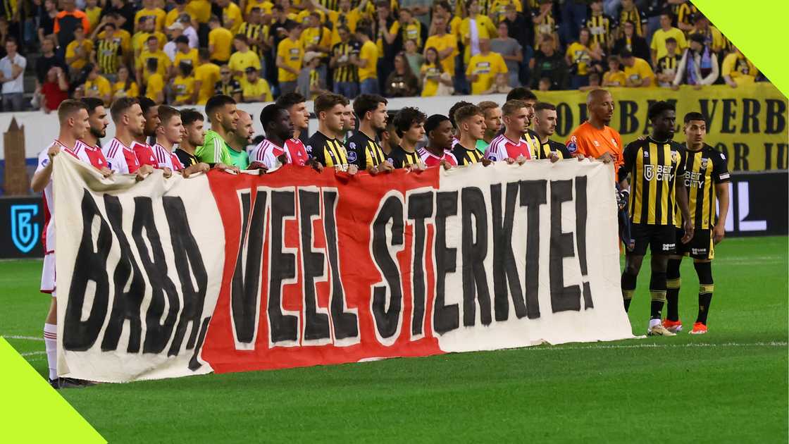 Vitesse and Ajax players hold a banner in support of Tijani Babangida