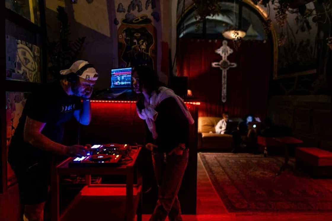 The watering hole has become a home away from home where tattooed young people drink beer, roll cigarettes and mingle in their mother tongue The watering hole has become a home away from home where tattooed young people drink beer, roll cigarettes and mingle in their mother tongue