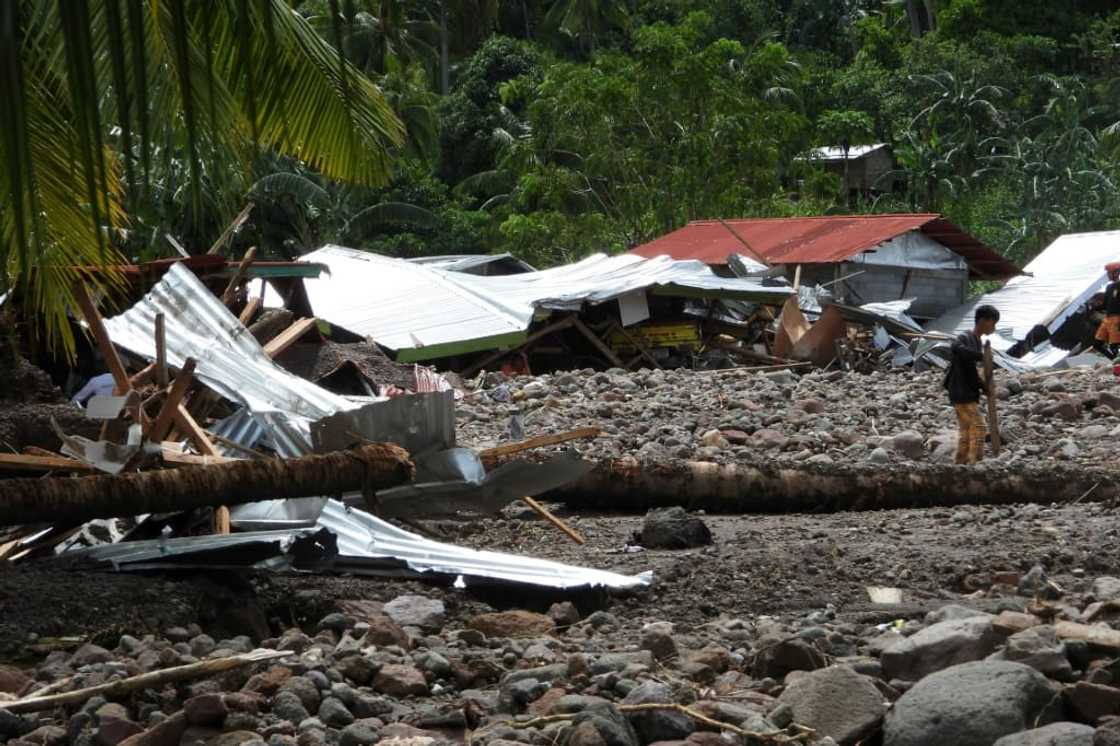 About 60 houses were buried, while a few others made of lighter materials were swept down towards the road below, said Lieutenant-Colonel Dennis Almorato About 60 houses were buried, while a few others made of lighter materials were swept down towards the road below, said Lieutenant-Colonel Dennis Almorato