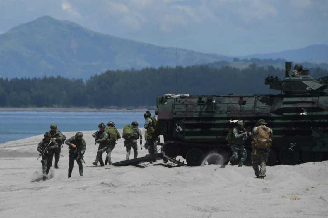 Philippine and US marines disembark from amphibious assault vehicles during a joint landing exercise at a beach Philippine and US marines disembark from amphibious assault vehicles during a joint landing exercise at a beach