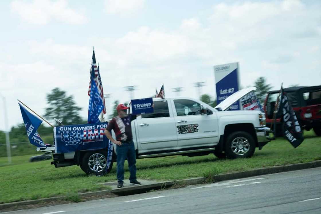 Supporters of former US president Donald Trump protest as US President Joe Biden's motorcade passes