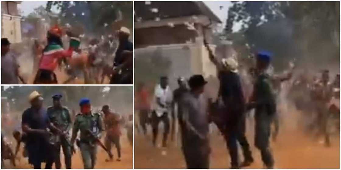Reactions as masquerade, others jostle to pick cash as man sprays money on street in video Reactions as masquerade, others jostle to pick cash as man sprays money on street in video