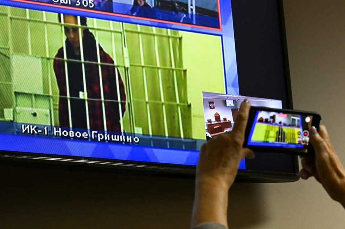 Jailed US basketball player Brittney Griner is seen on a screen via a video link during a court hearing near Moscow on October 25, 2022