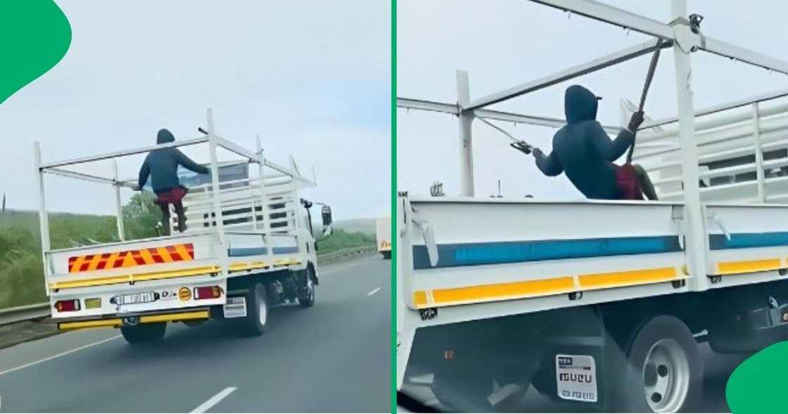 A KwaZulu-Natal man swings on the back of a truck on the highway.