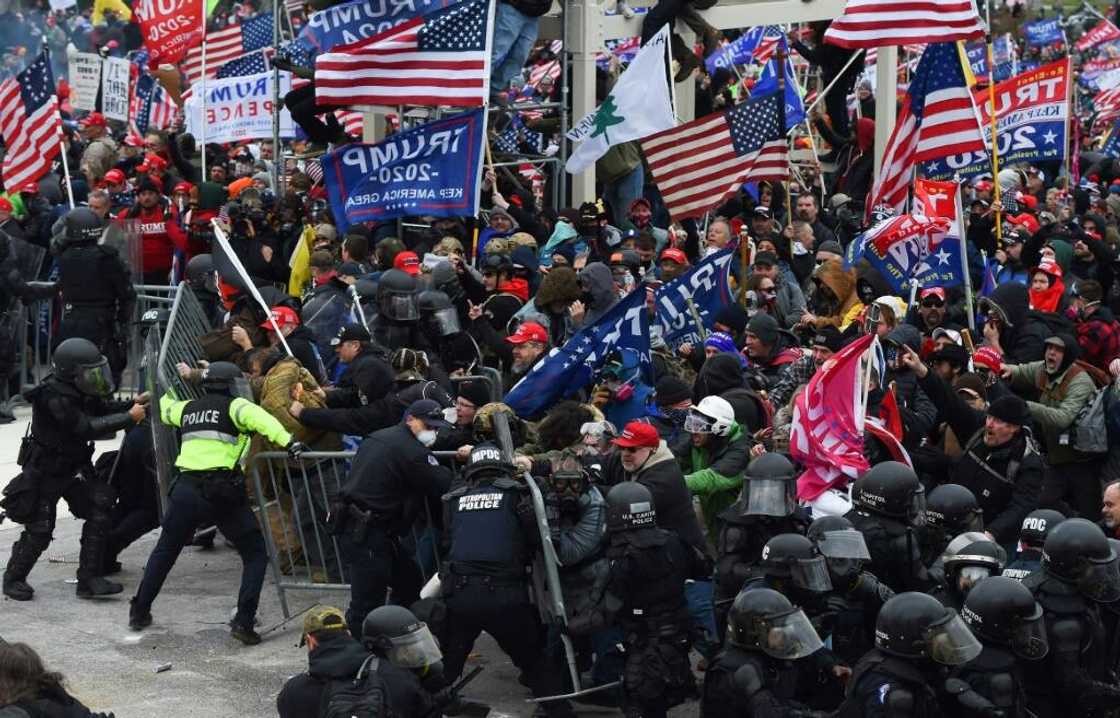 Rioters clash with police as they push barricades to storm the US Capitol in Washington on January 6, 2021