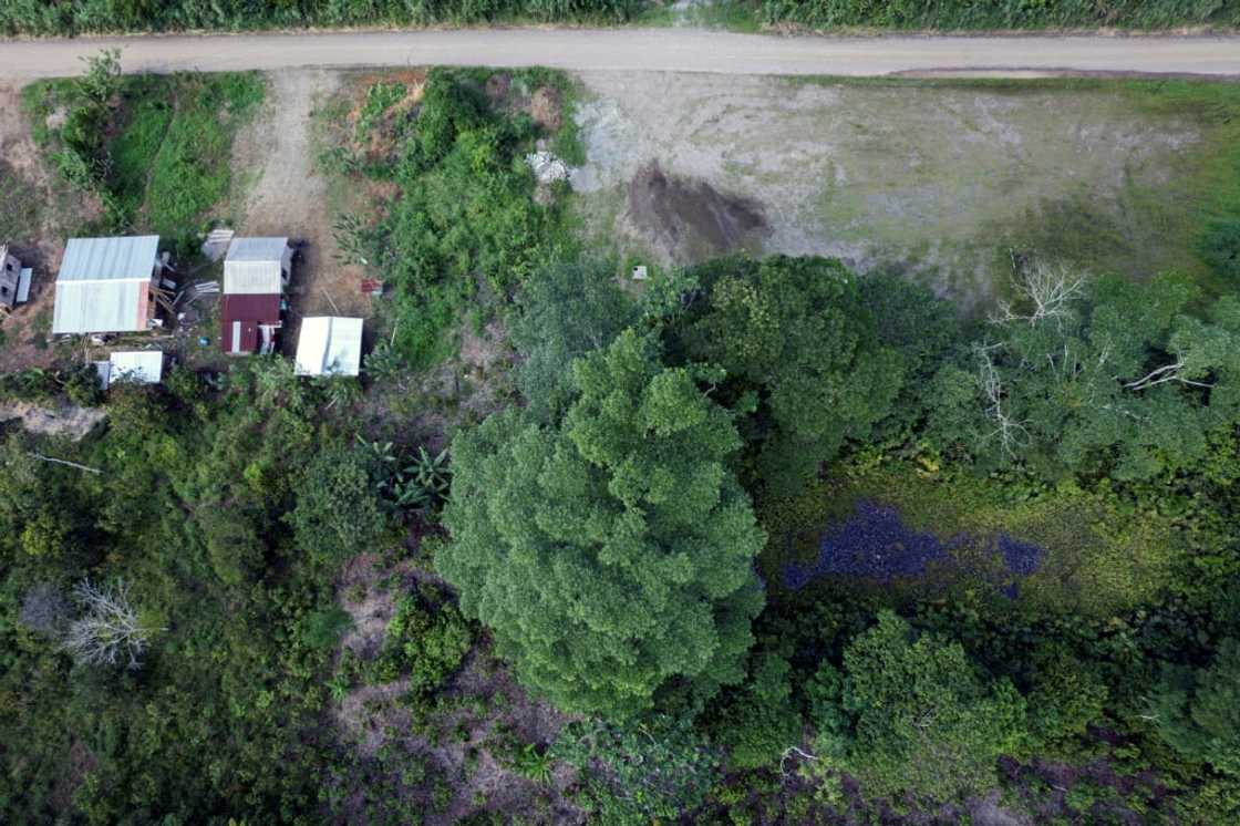 Houses stand near abandoned retention ponds that still contain toxic remnants of the oil production process Houses stand near abandoned retention ponds that still contain toxic remnants of the oil production process