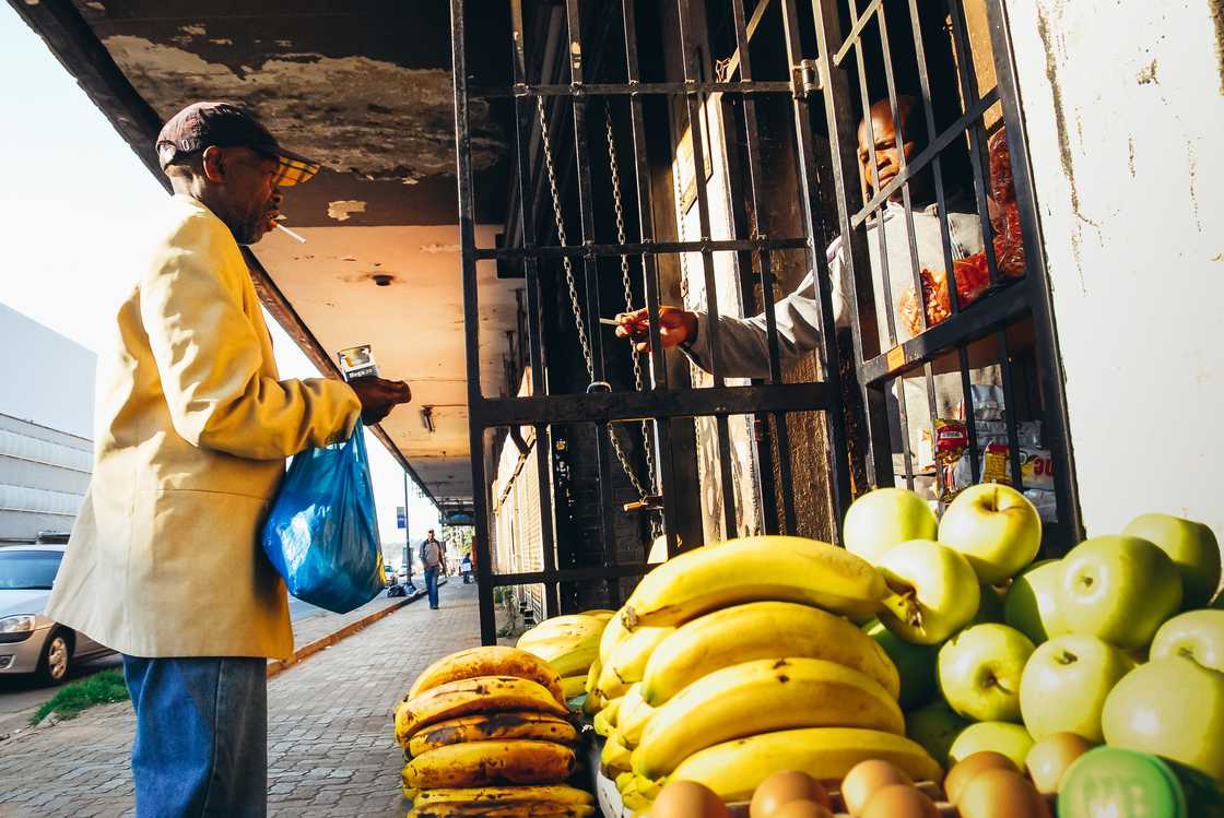 A customer outside a spaza shop. A customer outside a spaza shop.