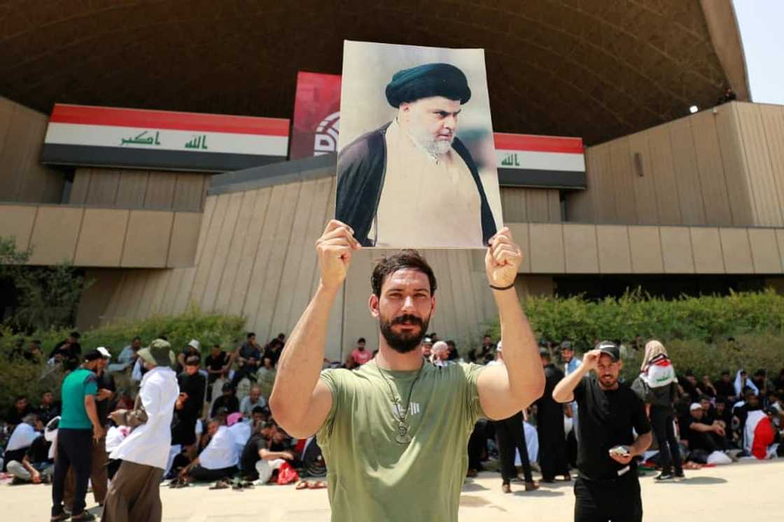 A Sadr supporter displays his portrait near the occupied parliament A Sadr supporter displays his portrait near the occupied parliament