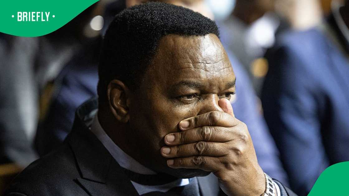 Suspended South African National Police Commissioner General Fannie Masemola reacts as he appears for charges linked to an irregular Medicare24 police tender, at the Pretoria Magistrate's Court in Pretoria on May 13, 2026