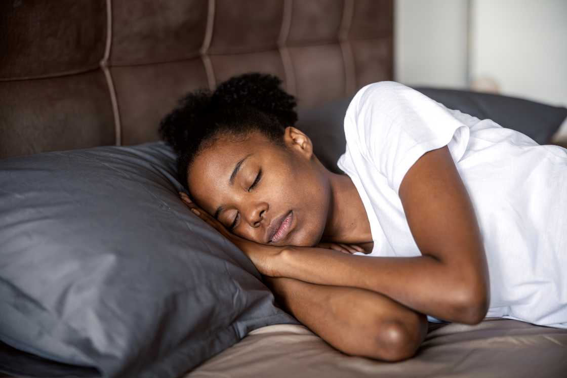 A young black woman peacefully resting