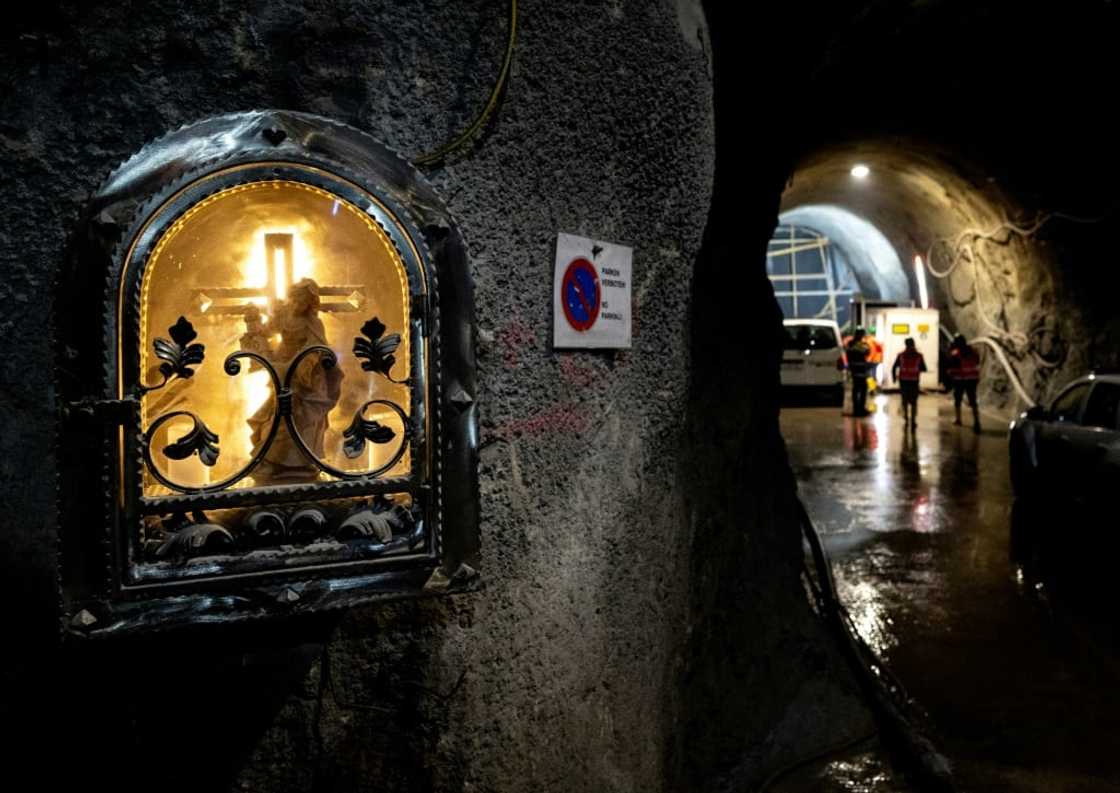 The vast subterranean construction site is dotted with statues of Saint Barbara, patron of miners and others plying dangerous trades