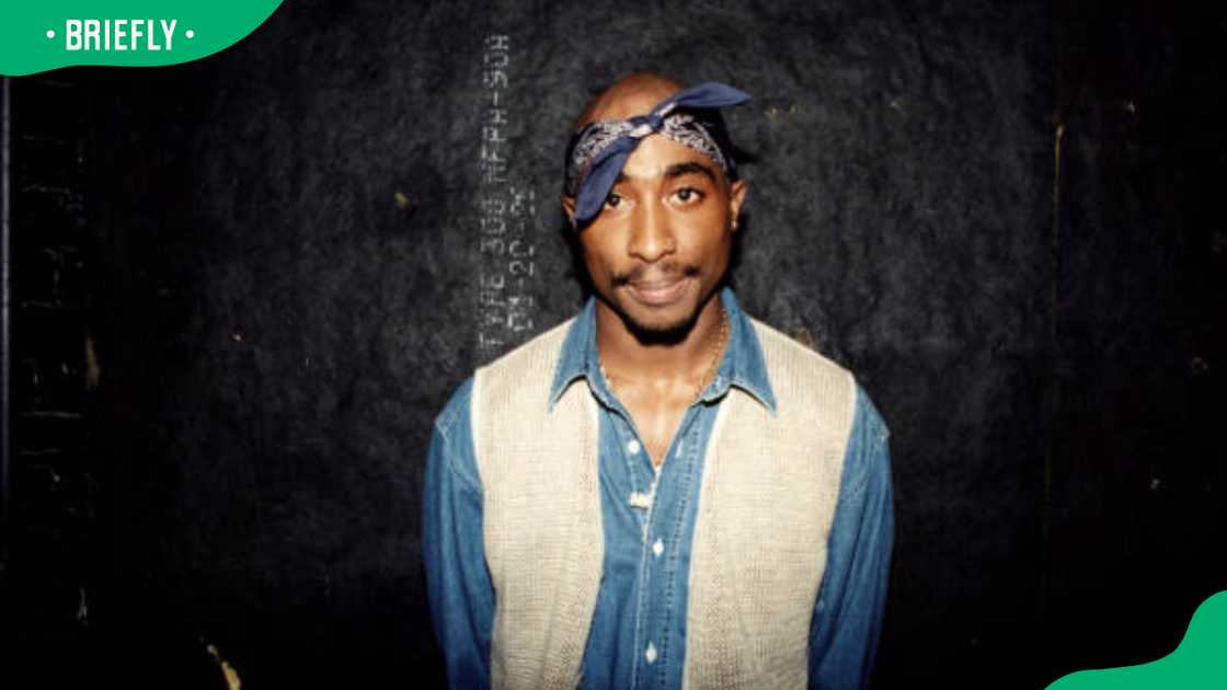 Tupac Shakur posing for a photo Tupac Shakur posing for a photo
