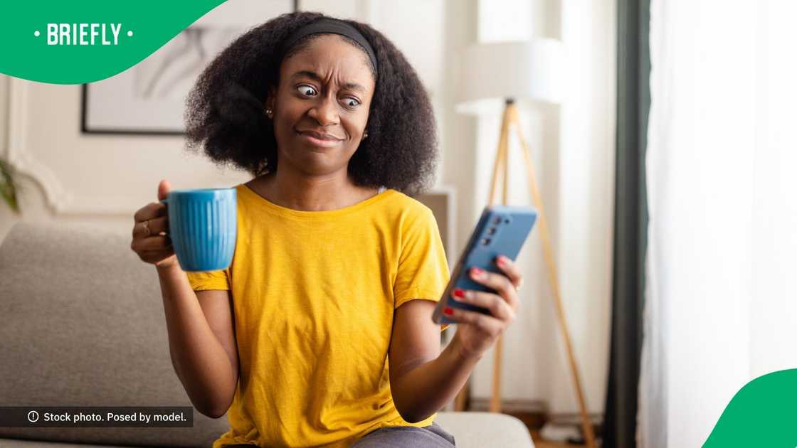 A confused woman looking at her phone. A confused woman looking at her phone.