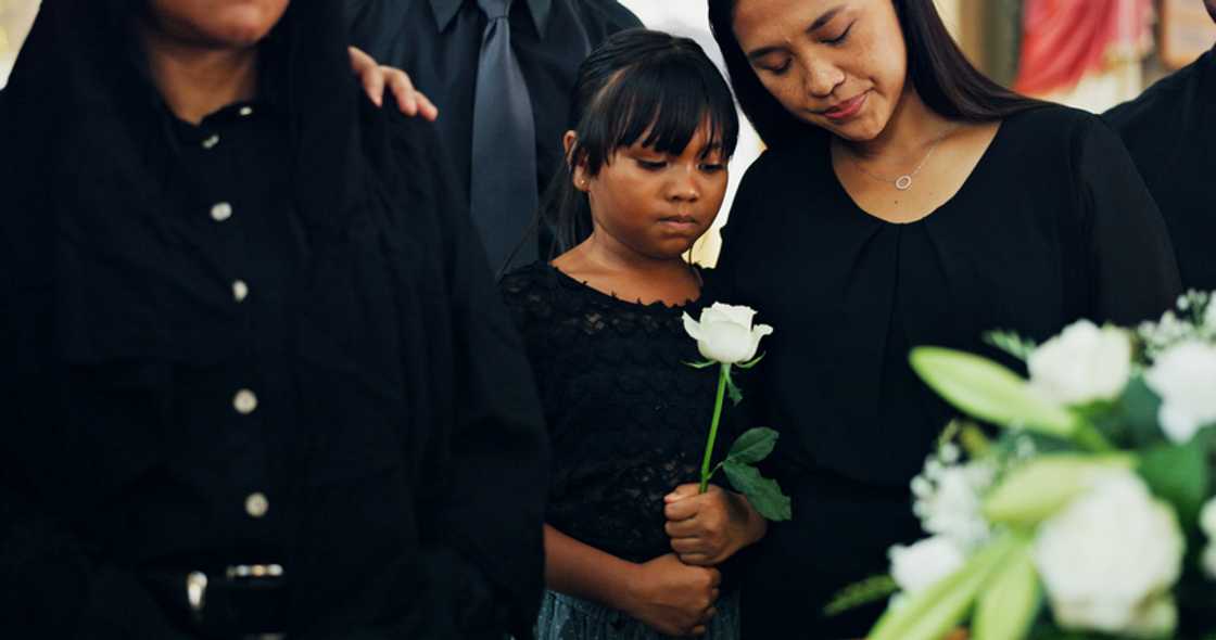 Two women stand apart at a funeral in Johannesburg. Two women stand apart at a funeral in Johannesburg.