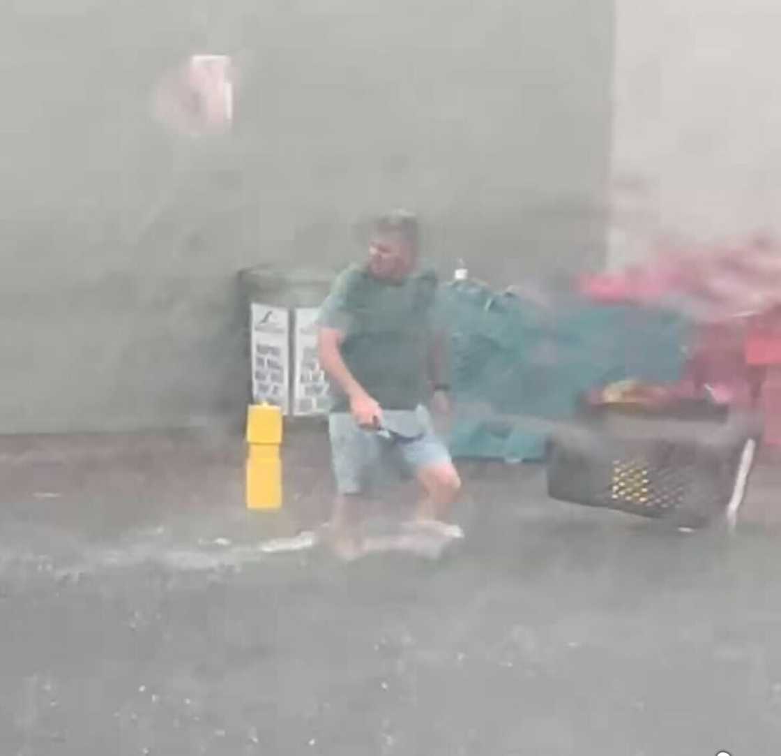 A man waded through the flooding at a KwaZulu-Natal shopping centre. A man waded through the flooding at a KwaZulu-Natal shopping centre.