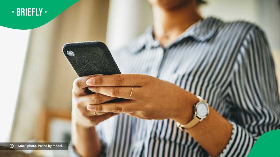 A woman typing on her phone. A woman typing on her phone.