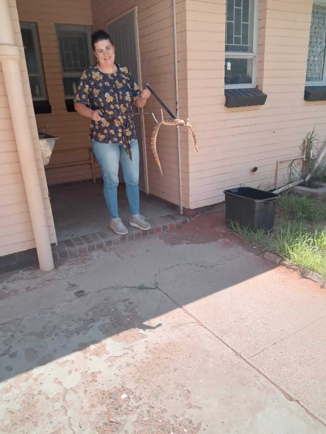 A police officer caught a snake.