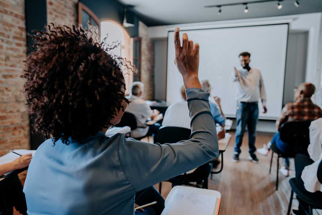 A woman raising her hand A woman raising her hand