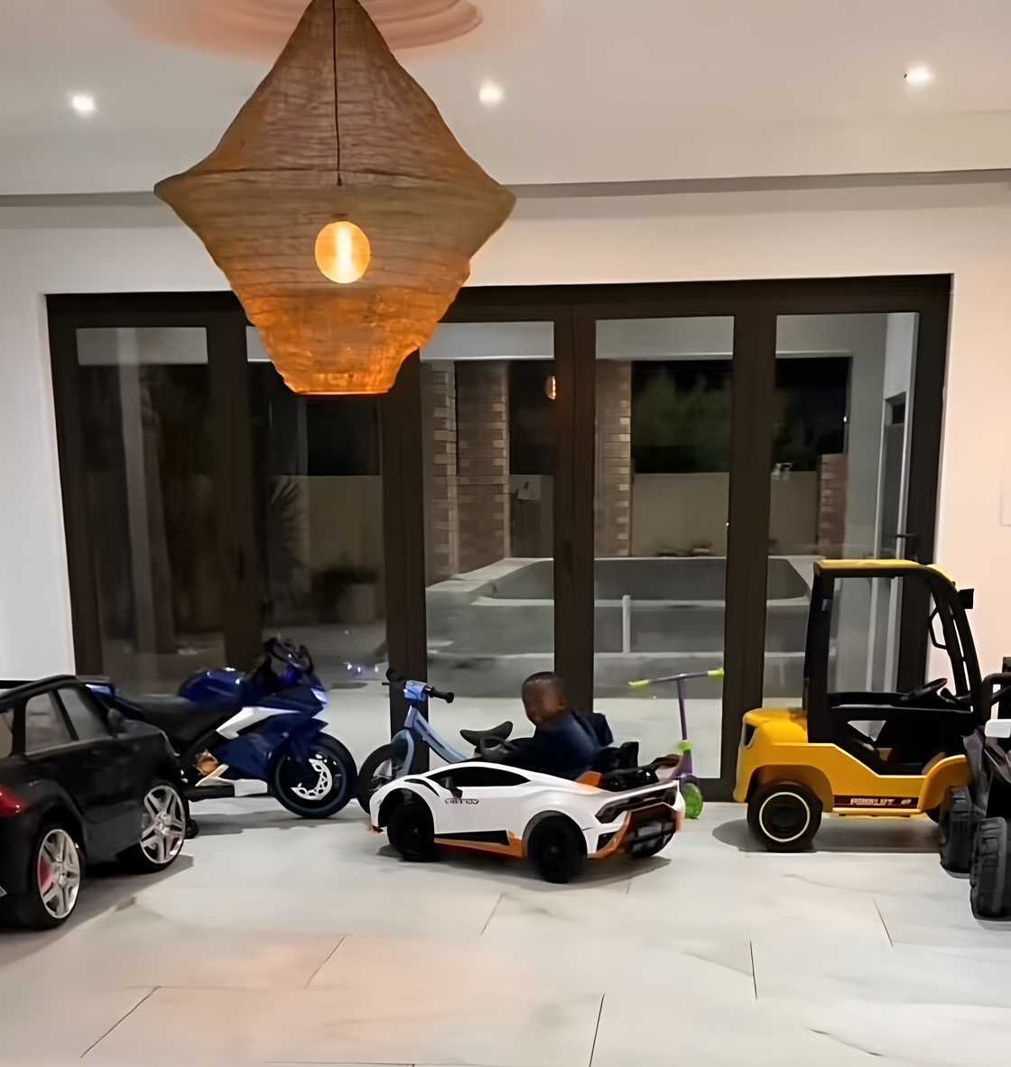 A toddler’s impressive drifting skills lit up a luxury mansion in a TikTok video. A toddler’s impressive drifting skills lit up a luxury mansion in a TikTok video.