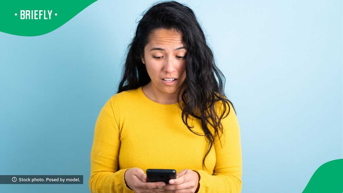 A confused woman using her phone. A confused woman using her phone.