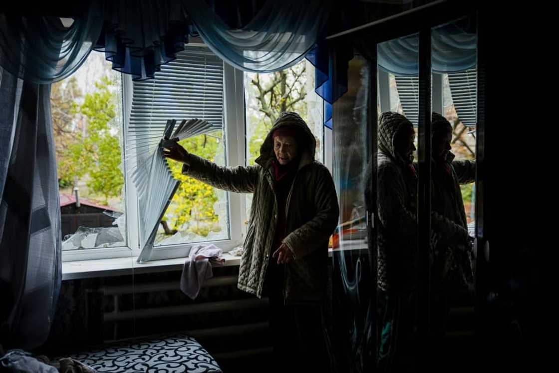An elderly woman examines her damaged home in Bakhmut An elderly woman examines her damaged home in Bakhmut
