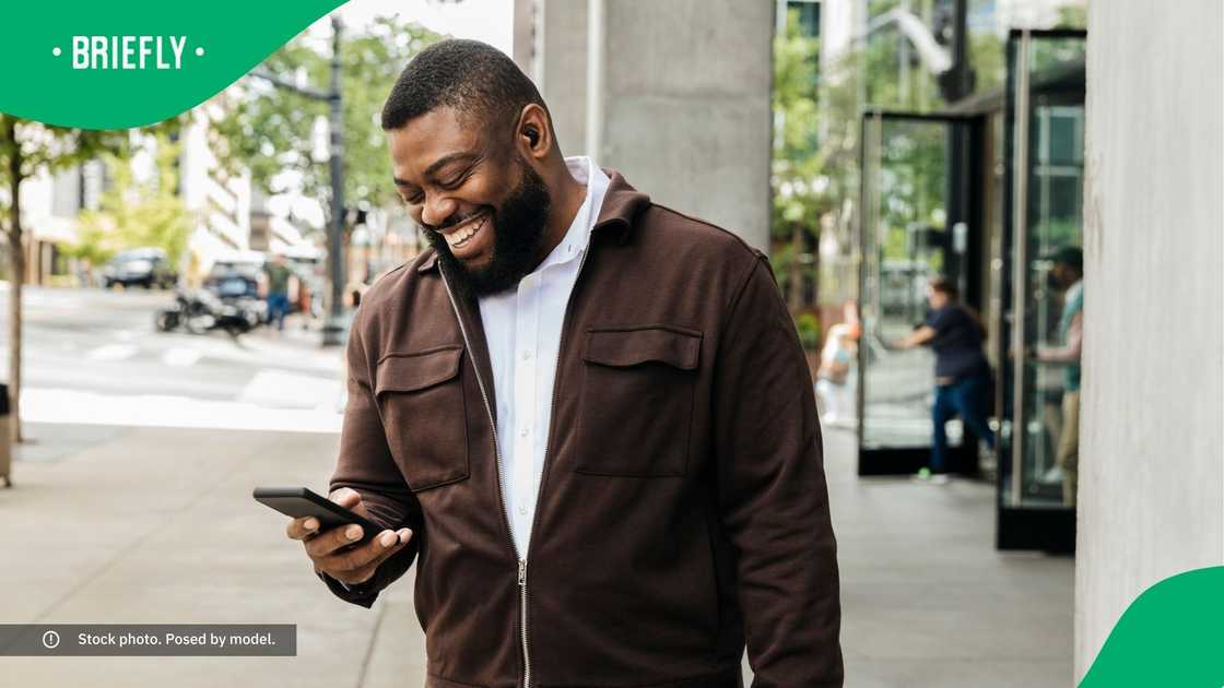 A man laughing at his phone.