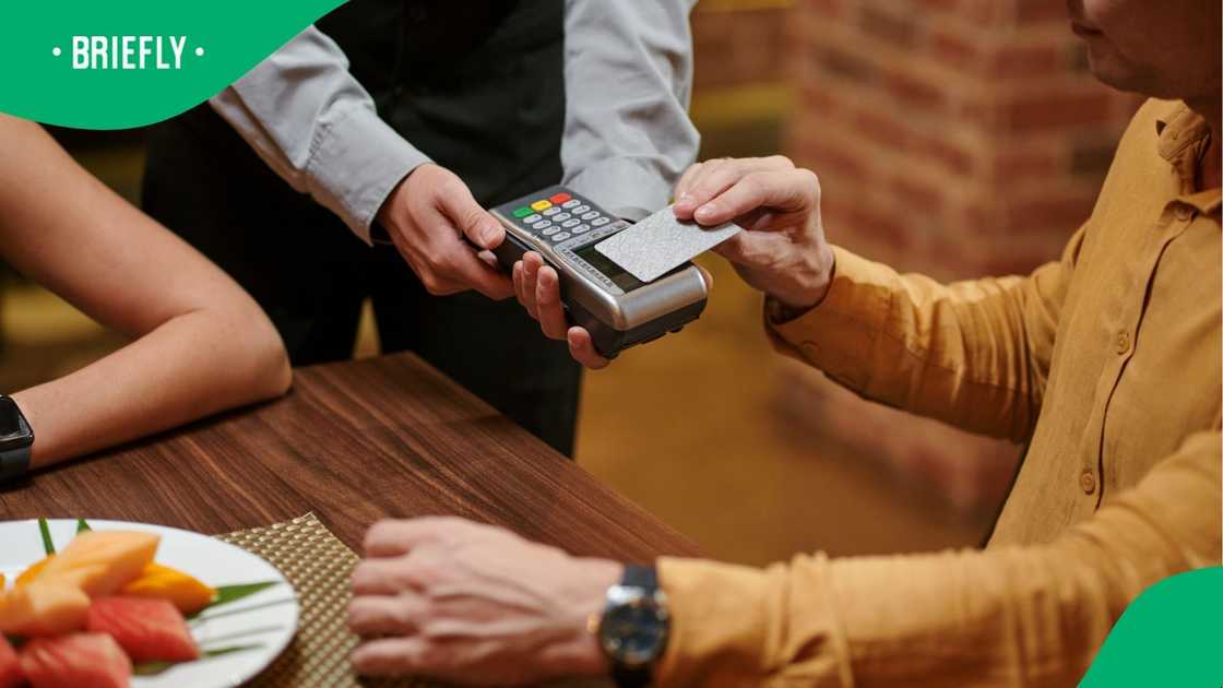 A man was snapped paying the bill at a restaurant