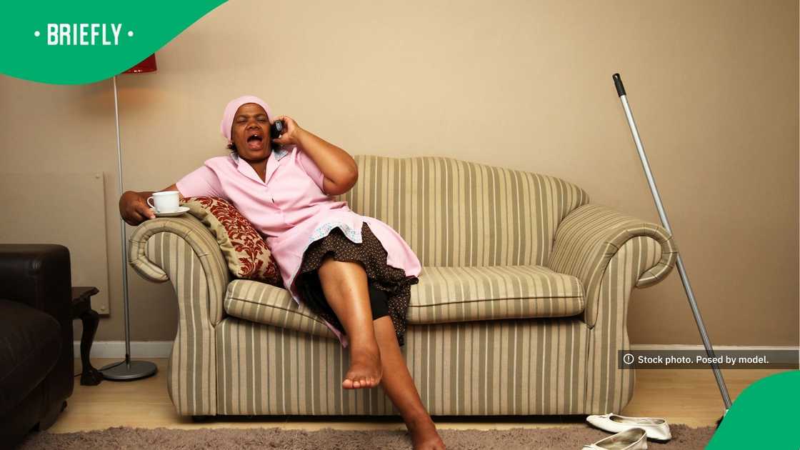 The visual captured a domestic worker taking a break The visual captured a domestic worker taking a break