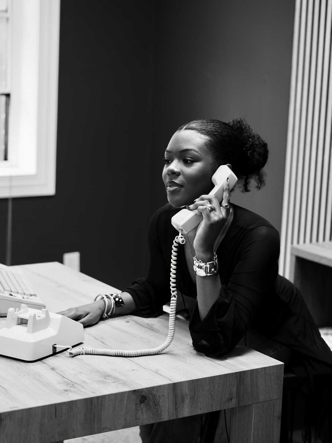 Novels Black young woman calling from the office.