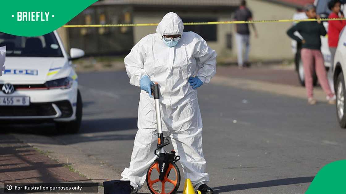 South African Police Service (SAPS) Forensic Investigators gather evidence from a crime scene in Westbury, near Johannesburg, on October 21, 2025