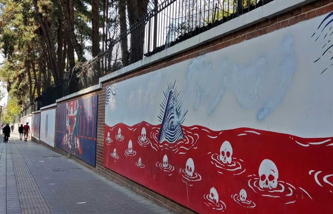The protest slogan "Woman, Life, Freedom" was spray painted on the wall of the former US embassy The protest slogan "Woman, Life, Freedom" was spray painted on the wall of the former US embassy